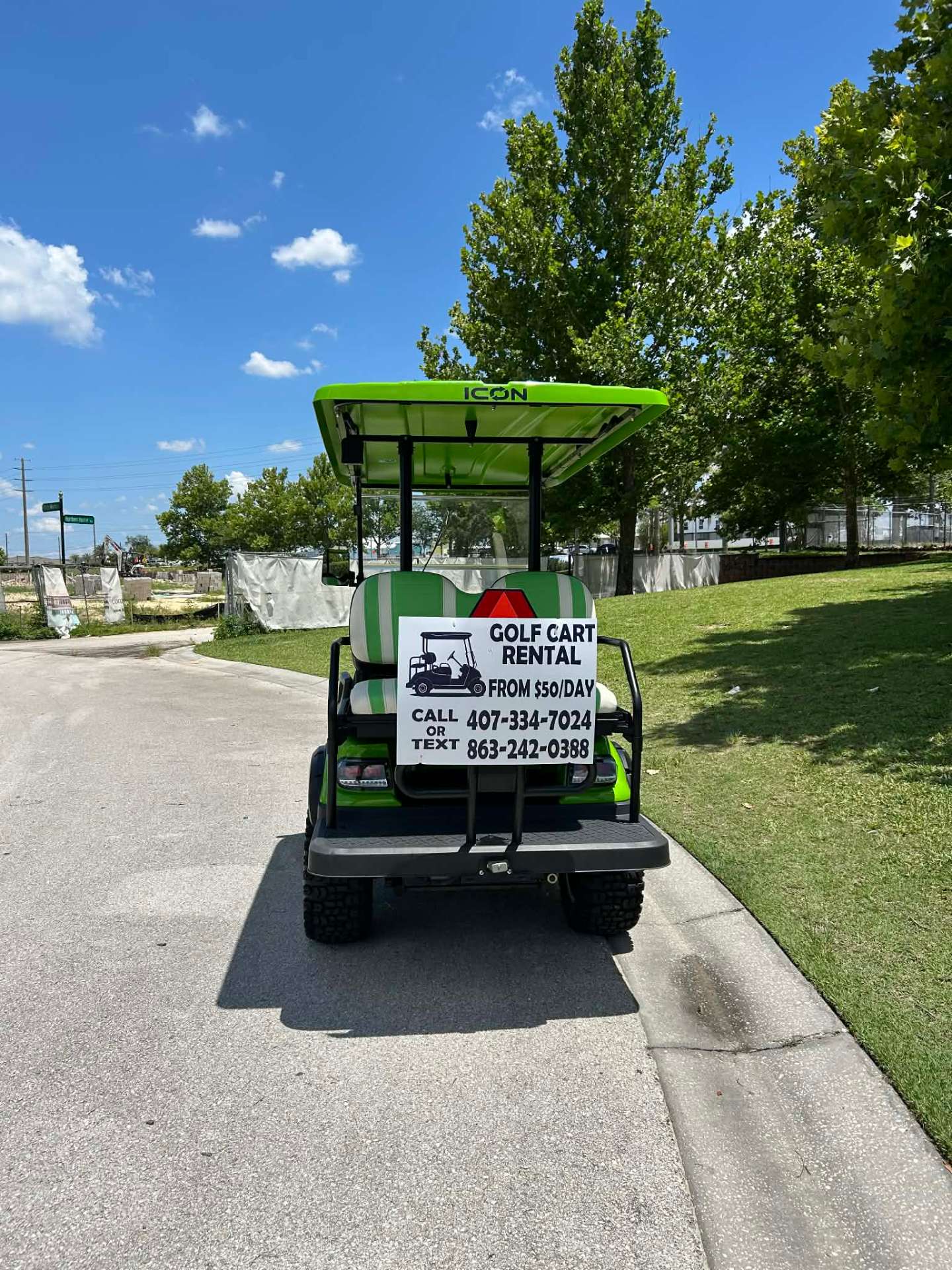 Black lifted golf cart with call or text rental sign at sunset in Reunion Resort