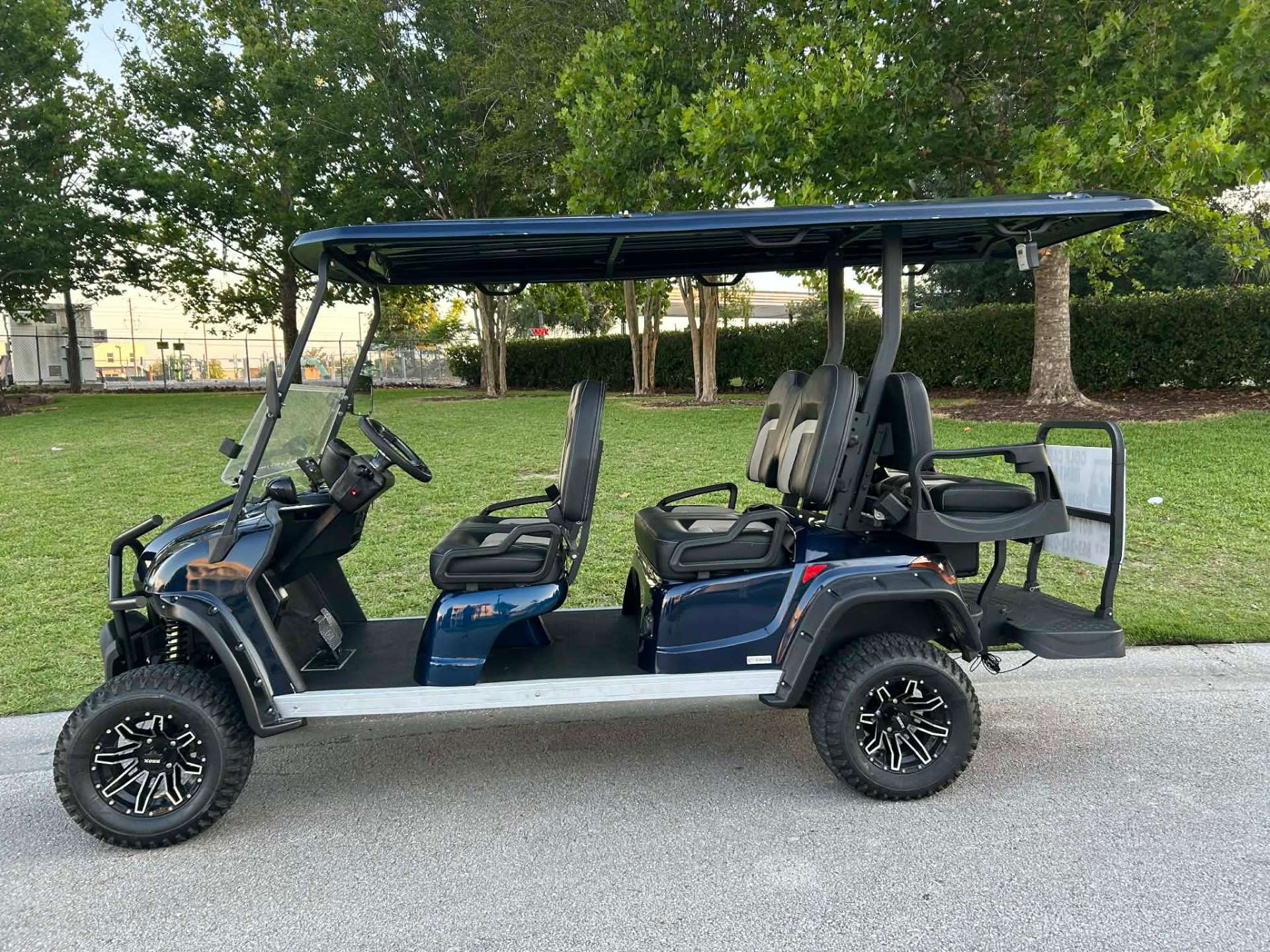 Navy blue 6-passenger lifted golf cart rental at an Orlando area park